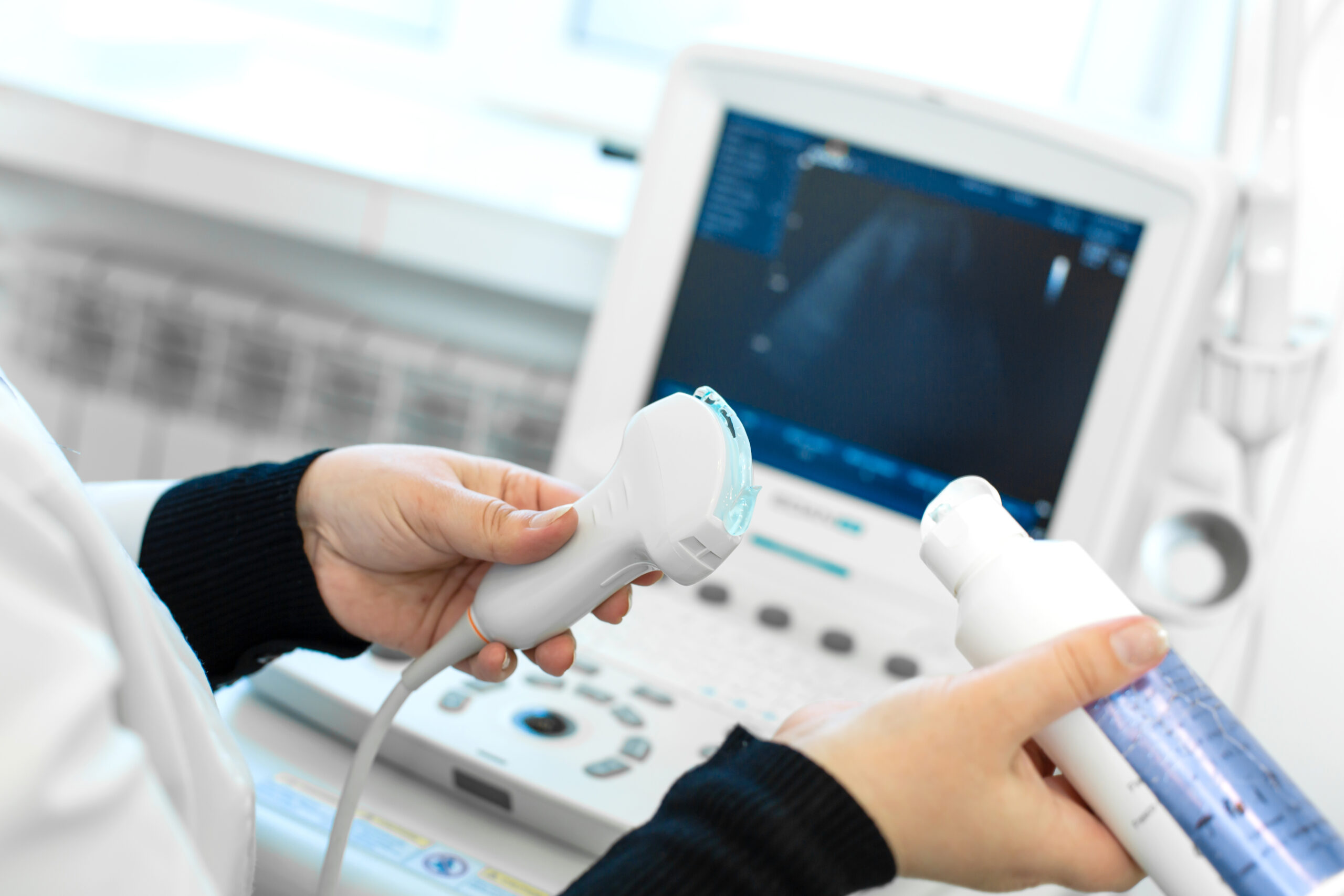 Doctor prepare an ultrasound machine for the diagnosis of a pati